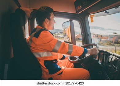 Garbage Removal Worker Driving A Waste Truck