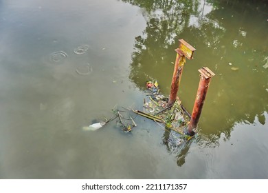 Garbage In The River Caught In The Iron Pillars Of The Former Bridge Foundation