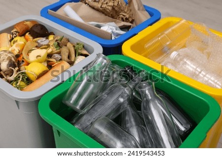 Garbage sorting. Full trash bins for separate waste collection indoors, closeup