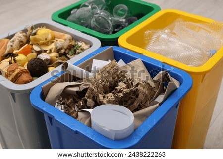 Garbage sorting. Full trash bins for separate waste collection indoors, closeup