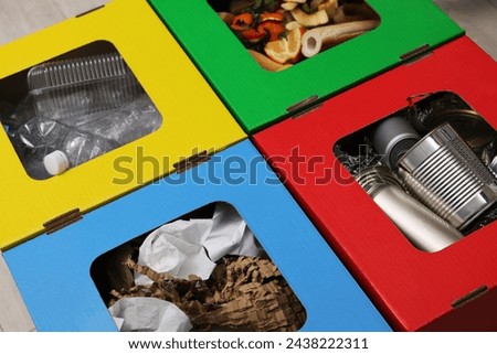 Garbage sorting. Full trash bins for separate waste collection indoors, closeup view