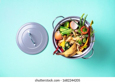 Garbage sorting. Organic food waste from vegetable ready for recycling in compost bin on blue backgrond. Top view. Sustainable and zero waste living. Environmentally responsible behavior, ecology - Shutterstock ID 1682244205