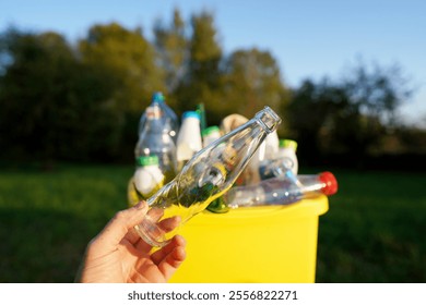 Garbage Sorting. Trash bin bucket. Bottles in Waste container. Waste sorting for Recycling. Glass bottle in trash bin container. Throwing bottles in trash can. Waste container with plastic bottles.