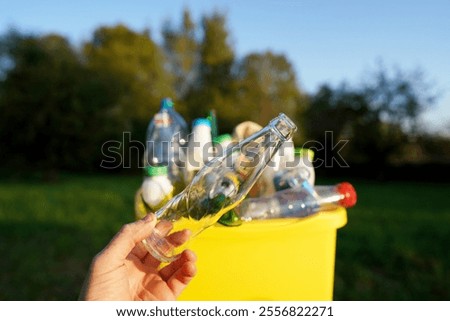 Garbage Sorting. Trash bin bucket. Bottles in Waste container. Waste sorting for Recycling. Glass bottle in trash bin container. Throwing bottles in trash can. Waste container with plastic bottles.