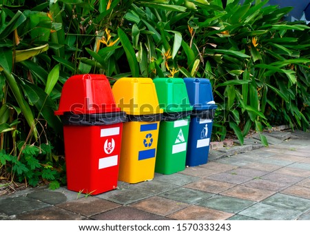 Garbage Sorting Trash Can red yellow green blue ,Household Siamese Plastic ,Classification Trash Can,small Barrel Recyclable bin on sidewalk front tropical tree