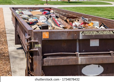 Garbage, trash or waste dumpster full of household junk. Concept of cleaning, cleanup, hoarding and disposal