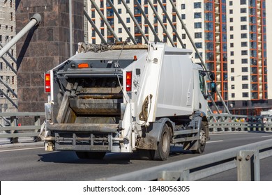 Garbage Truck Driving On The Highway In The City, Back View