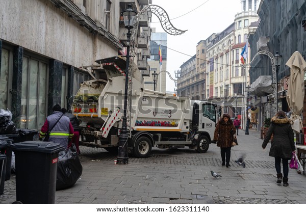 Garbage truck in the\
morning collecting garbage from the streets of the Old Town of\
Bucharest, Romania,\
2020