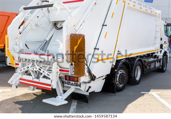 Garbage truck on the street. Municipal\
and city services. ?lean future ecology\
concept