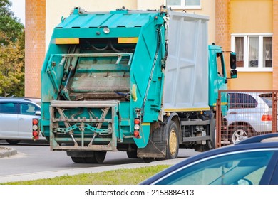 A Garbage Truck Picks Up Garbage In A Residential Area. Loading Mussar In Containers Into The Car. Separate Collection And Disposal Of Garbage. Garbage Collection Vehicle