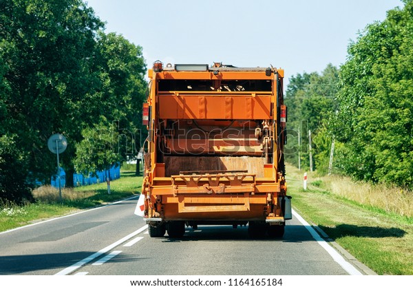 Garbage truck in the road in\
Poland.