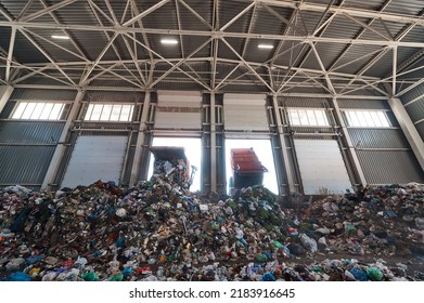 Garbage Truck Unloads Household Waste In The Receiving Chamber Of A Waste Sorting Plant