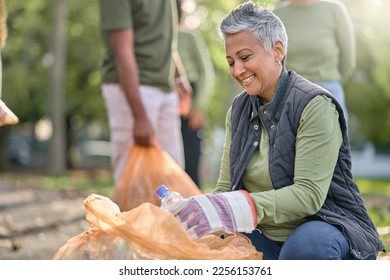 Garbage, volunteer and senior woman cleaning trash, pollution or waste product for environment support. Plastic bottle container, NGO charity and eco friendly community help with nature park clean up - Powered by Shutterstock