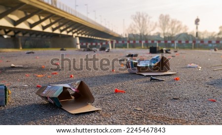 Garbage and waste of New Year´s fireworks lying around on tarmac in urban street area