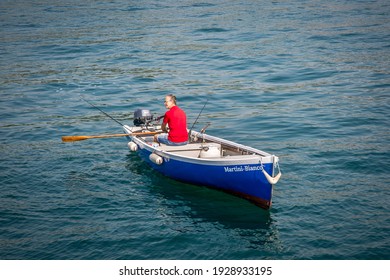 GARDA, ITALY 14 SEPTEMBER 2019: A Man On A Boat Ride On The Oars, On Lake Garda. Veneto, Italy