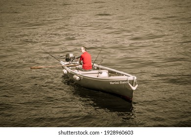 GARDA, ITALY 14 SEPTEMBER 2019: A Man On A Boat Ride On The Oars, On Lake Garda. Veneto, Italy