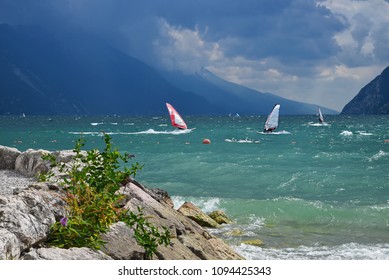 Garda Lake On A Windy Day, Surfers Paradise Riva Del Garda, Italy. Swan Family In The Waves