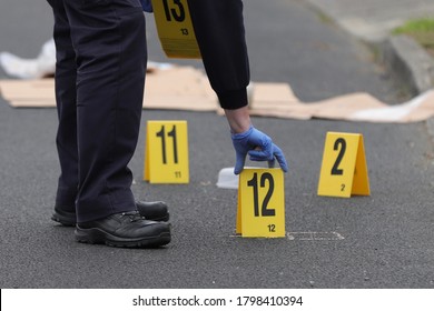 A Garda Police Crime Scene Investigator Places An Evidence Marker At A Crime Scene During An Examination Of A Hit And Run In Dublin, Ireland, August 10th, 2020.