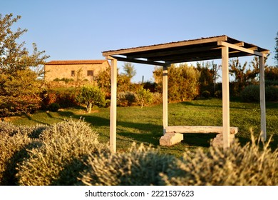 The Garden With Bench Of A Country House In The Famous Tuscan Hills, Tuscany, Italy.