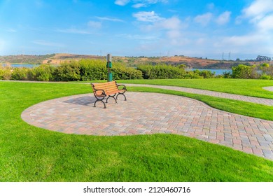 Garden bench on a stone bricks ground near the Agua Hedionda Lagoon at Carlsbad, San Diego, CA