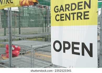 garden centre open sign on fence with calm road behind, yellow white and black - Powered by Shutterstock