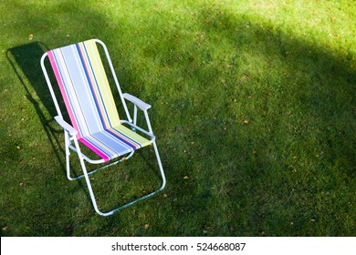 Garden Chair On Green Lawn Background