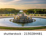 Garden of Chateau de Versailles and the Latona Fountain, near Paris in France at sunset
