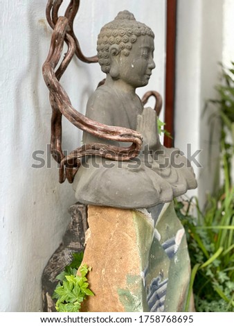 Garden concrete Buddha culpture in welcoming anjali pose