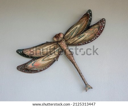 garden decoration, metal dragonfly on the wall 