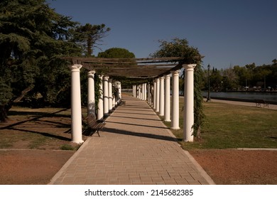 Garden Design. General San Martín Park In A Sunny Day. View Of The Walkway, Plants And Decorative White Columns.