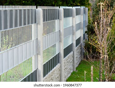 Garden Fence Made With Decorative Galvanized Wire Fence Panels Inserted In To The Concrete Columns.