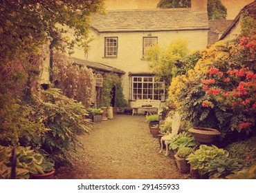 Garden At The Front Of  Old House, Lake District, Cumbria, UK.  Photo In Retro Style.  Added Paper Texture.