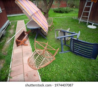 Garden Furniture And Sun Umbrella Turned Over After Storm, Outdoor Shot