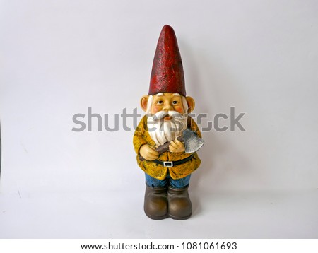 Garden gnome with red hat, yellow jacket, blue trousers and brown boots. He has an ax in his hand. 
Isolated on white background.
