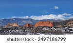 Garden of The Gods at the foot of the Rocky Mountains show of their red rocks on a early winter morning against the blue Colorado sky and Pikes Peak