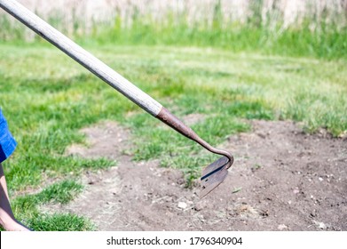 Garden Hoe Being Used On Bare Dirt To Turn Over Soil 