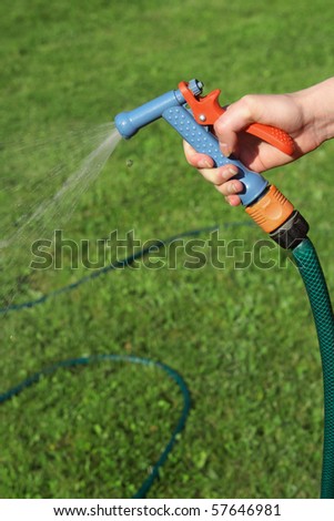 Garden hose in women's hand.