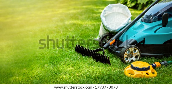 garden lawn care tools and equipment for perfect\
green grass. banner copy\
space