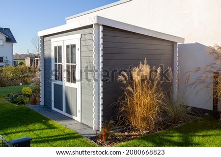 Garden with new wooden tool shed