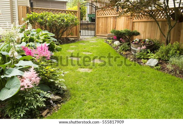 Garden Path. Back yard path leads\
past garden in bloom during transition from spring to\
summer.