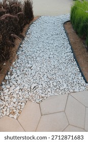 A garden path and border using landscape edging, which helps define different areas and materials in a garden. 
