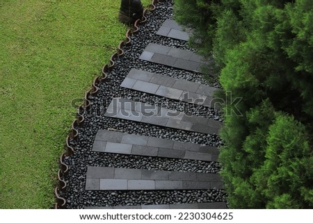The garden path is made of stone.
