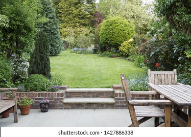 Garden patio with furniture and lawn in a typical English back garden in London, UK