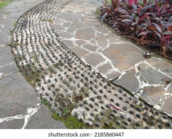 A Garden With A Pebble Walkway Set Up For Foot Reflexology.