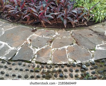 A Garden With A Pebble Walkway Set Up For Foot Reflexology.