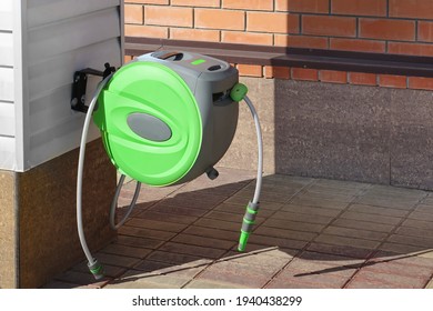 Garden Retractable Green Hose Reel With Sprinkler Or Sprayer. 