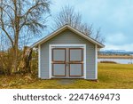 Garden shed front. Gardening tools shed. Garden house, wooden tool-shed. Single-story roofed structure in a back garden used for storage, hobbies, or workshop. Nobody, selective focus