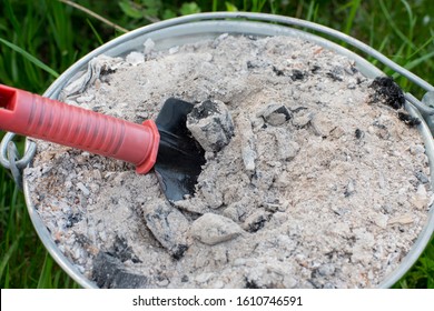 Garden Shovel In A Container With Ash. Organic Fertilizer For Plants. Modern Responsible Farming.
