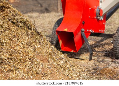 Garden shredder. A pile of wood chips with a branch crusher. Mulch bark for decoration and weed control. - Shutterstock ID 2137994815