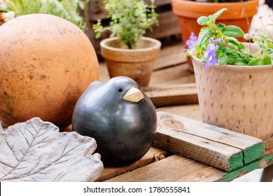 Garden Table Decoration With Ceramic Blackbird And Flowerpot Showing Gardener Lifestyle And Home Backyard Detail For A Joyful Time Out In Summer And Spring Gardening